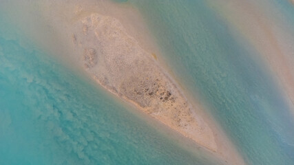 Aerial panorama of the Brussa lagoon, Veneto. Crystal clear and emerald water. Curved and circular shapes. Atoll.