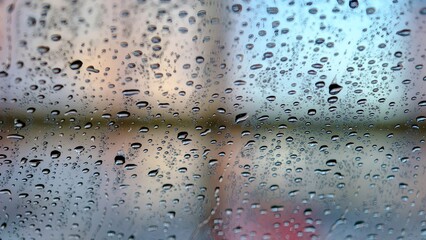 Car window glass after washing. It is covered with water droplets on the outside.