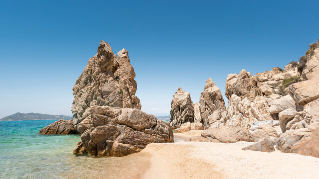 Panoramic view of exotic sandy beach with crystal clear water and phenomenal rock formations. Greece, Halkidiki, Athos peninsula, Trimi beach, Ouranoupolis. Travel, summer holiday, vacation