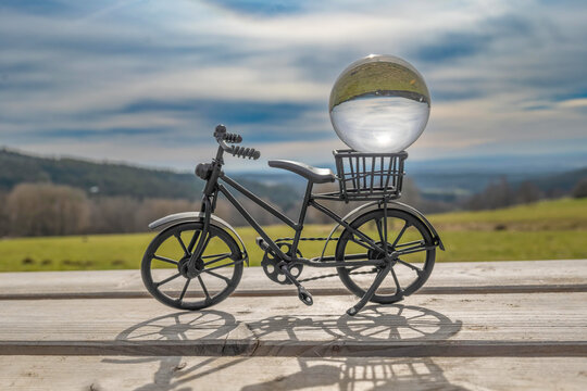 a small decorative bicycle with a glass ball