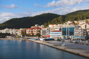Fototapeta na wymiar View of Igoumenitsa city harbor, with passenger port, ferry terminal, mountains and Ionian sea, Epirus, Thesprotia, Greece in a summer sunny day with blue sky
