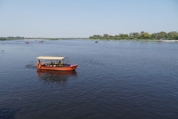 Fototapeta na wymiar people riding on a boat and enjoying together image yamuna river vrindavan