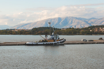 View of Igoumenitsa city harbor, with passenger port, ferry terminal, mountains and Ionian sea, Epirus, Thesprotia, Greece in a summer sunny day with blue sky