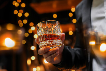Closeup businessmen holding a glass of whiskey