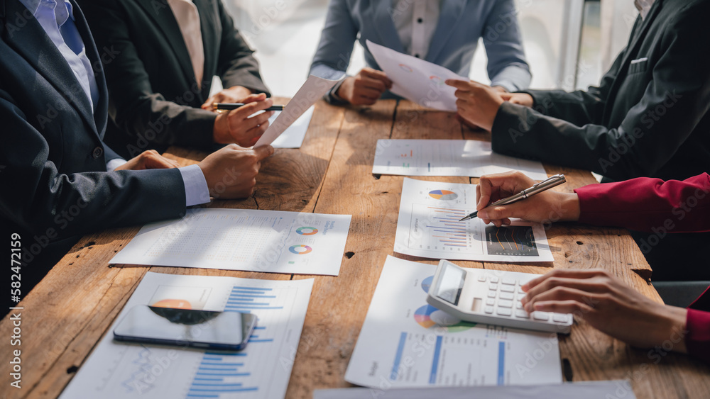 Wall mural Team of lawyers and tax auditors brainstorming together and calculating the balance sheet and historical financial accounts of the company and shareholders. to detect mistakes and prevent bribery