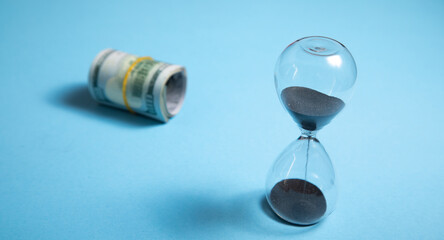 Hourglass with a dollar banknote. Business
