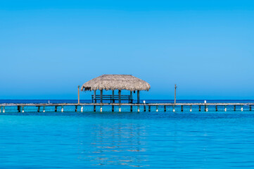 A view acros a jetty close to West Bay on Roatan Island on a sunny day