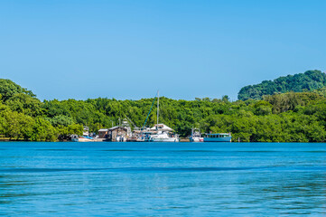 A view of boats in a cove next to West Bay on Roatan Island on a sunny day