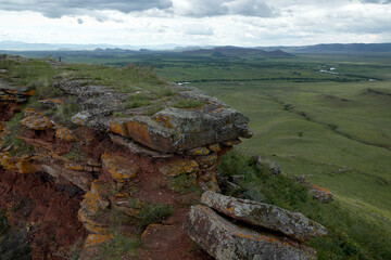 View of the steppe mountains and the lake from the top of the mountain in the chests park in Khakassia. The mountain ridge of Sunduki is a natural and historical monument of nature. 