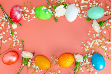 Banner. Easter frame with eggs and flowers on a pink background. Minimal concept. View from above. Card with copy space for text.