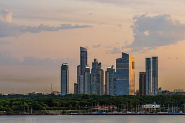 Fototapeta na wymiar Large modern apartment buildings of Puerto Madero by the shoreline in Buenos Aires Argentina at sunset