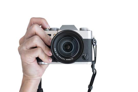 Hand holding vintage camera shooting front view isolated on transparent background