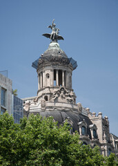 Fototapeta na wymiar Ornate dome and statue on top of building on Passeig de Gracia Barcelona Spain