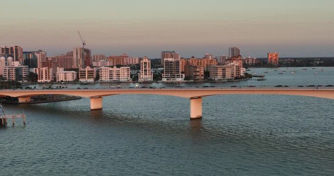 Evening aerial video of the Sarasota, Florida skyline and Ringling Parkway Bridge across Sarasota Bay	