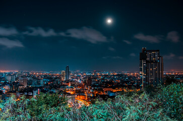 Pattaya city at night with full moon in the sky