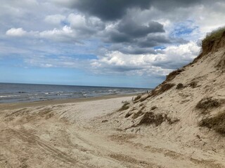 Fototapeta na wymiar Sandy coastline with a small hill