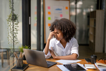 business woman sitting at work stressed , out working hard Feeling stressed out and dizzy from your...