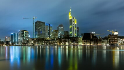 Fototapeta na wymiar View on Frankfurt skyline at night with reflection in the water, Germany