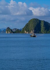 Fototapeta na wymiar Rock formations with the landscape and boats view in Ha Long Bay, Vietnam