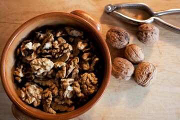 Closeup shot of brown small nuts in the wooden bowl