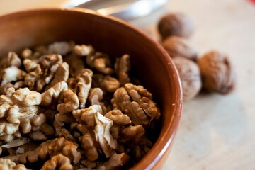 Closeup shot of brown small nuts in the wooden bowl