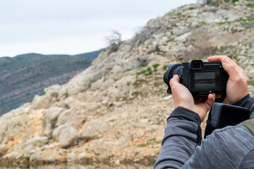 One man using a professional DSLR camera outdoors.