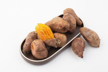 roasted sweet potatoes on a black background