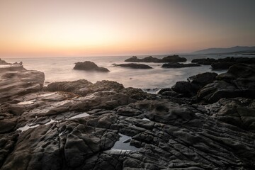 Fototapeta na wymiar Landscape view of the sunset over the rocky seascape