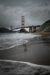 Fototapeta premium Beautiful view of a bridge over ocean water with cloudy sky