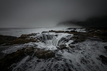 Breathtaking cinematic view of Thor's Well on foggy day in Oregon, USA