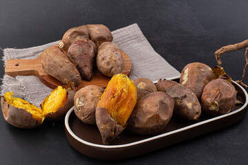 roasted sweet potatoes on a black background