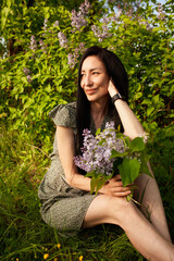 Facial close-up portrait of youthful female  posing against green trees, smiling widely, feeling free, enjoying hot summer day. 