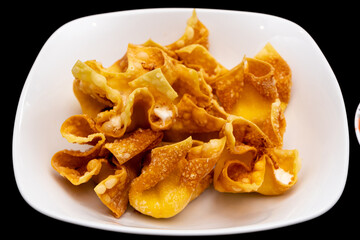 Overhead view of crab rangoons on a black background © john