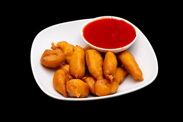 Front view of sweet and sour chicken on a black background