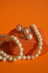 pearl jewelry, beads around the neck, a gold ring with pearls and earrings. women's necklace. background for the design.