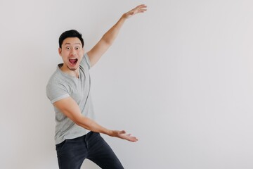 Full portrait of shock face Asian man looking at empty space isolated on white.