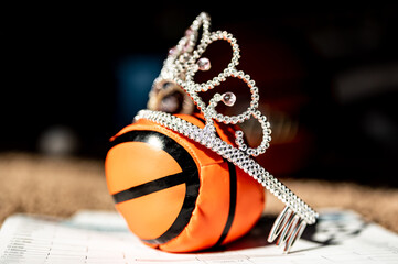 Basketball, tiara, and blank bracket signifying a Cinderella season.