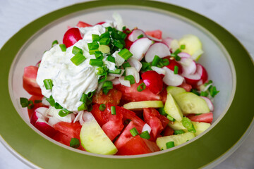 Served with tomatoes, radish and green onions, this salad is fresh and healthy.