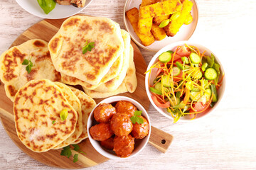 meal with meatballs, salad and flatbreads
