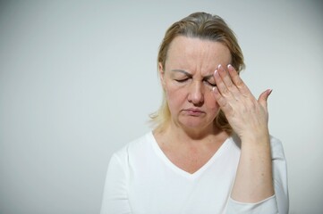 woman put her hand on her head and grimaced headache hard time woman tired she has grown gray hair