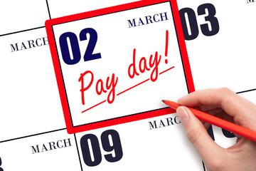 Hand writing text PAY DATE on calendar date March 2 and underline it. Payment due date