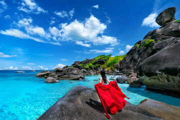 Beautiful girl standing on the rock at Similan island, Thailand.