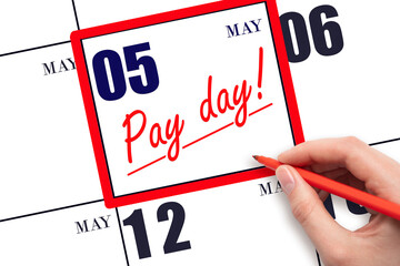 Hand writing text PAY DATE on calendar date May 5 and underline it. Payment due date