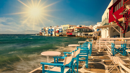 Chairs with tables in typical Greek tavern in Little Venice part of Mykonos town, Mykonos island, Greece - Travel and tourist concept