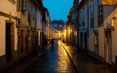 Fototapeta na wymiar The rain-soaked plazas and historic buildings of Santiago de Compostela, Spain, take on a glistening beauty under the glow of streetlights