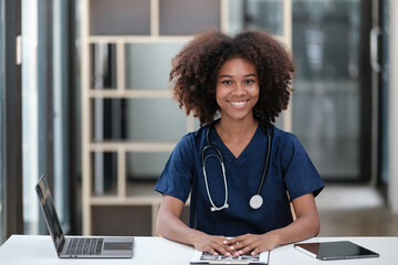 Portrait of female African American doctor with Stethoscope in her office at clinic.
