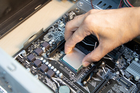 top view technician inserting cpu, computer assembler