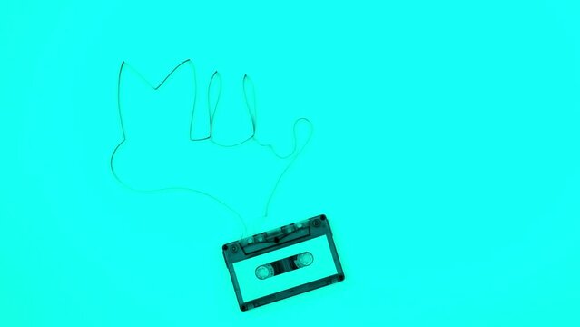 retro cassette tape is appear on the white background and the word music is formed from a cassette tape