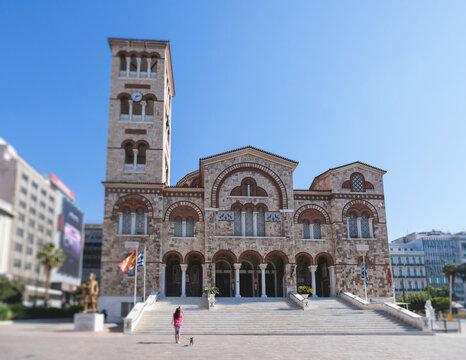 Hagia Triada neo-byzantine Cathedral facade exterior in Piraeus, Holy Trinity Greek Orthodox church, Piraeus city street view, Attica, Greece, summer sunny day with a blue sky