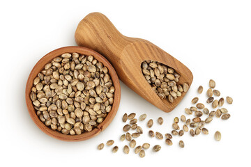 Hemp seeds in wooden bowl isolated on white background with full depth of field. Top view. Flat lay